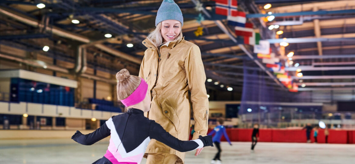 girl-ice-skating-with-mother-UHKTDAX.1